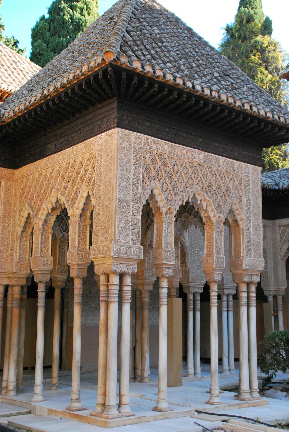 Detailed Moorish architecture in the Alhambra courtyard with carved columns and arches