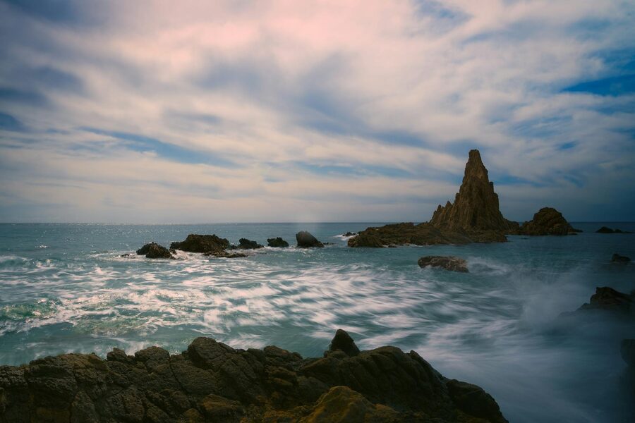 Dramatic rocky seascape near Almeria at sunset with golden light