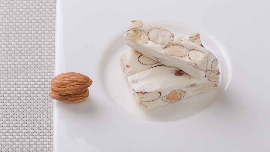 Traditional almond nougat sliced on a surface