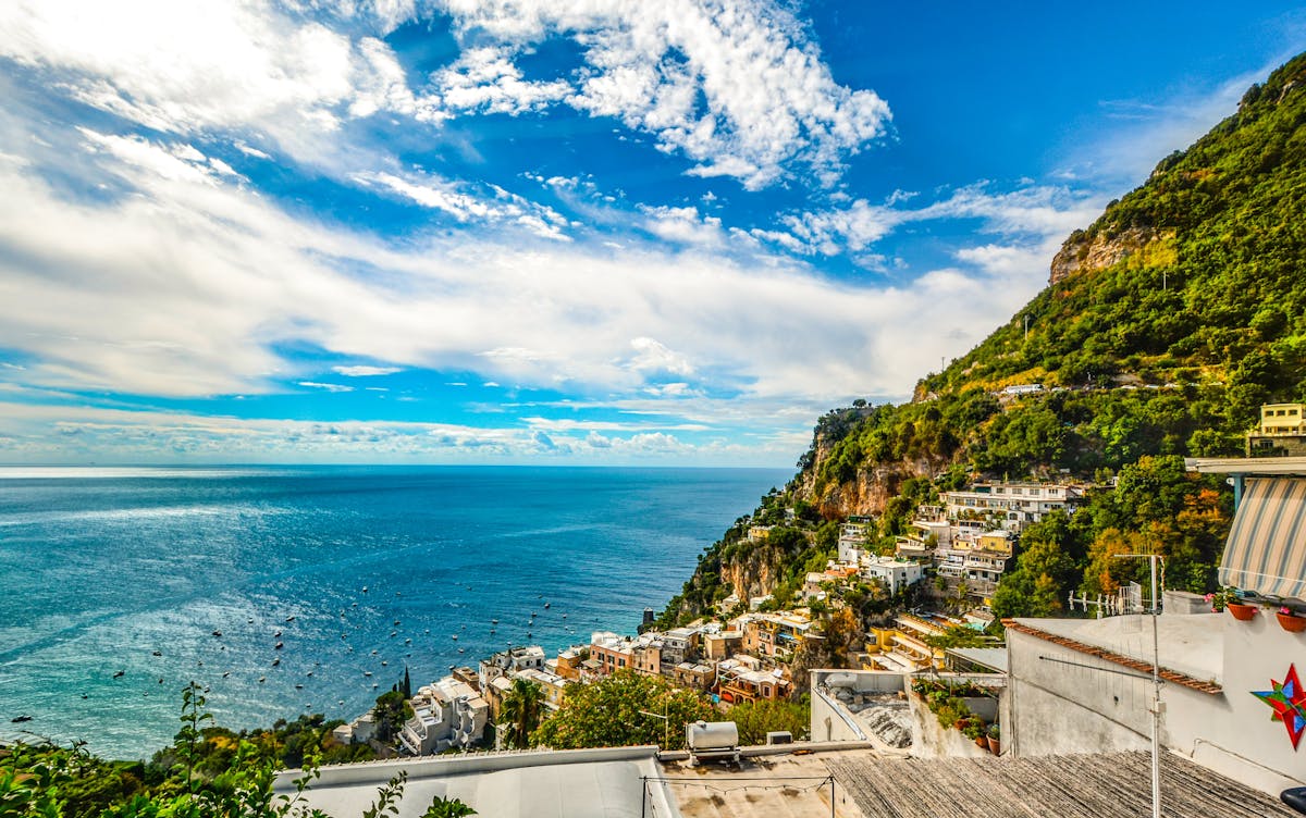 Amalfi Coast with vibrant blue sea and green hills