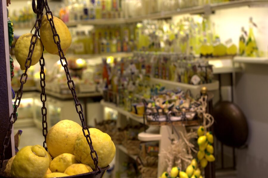 Fresh Amalfi lemons and limoncello bottles on display