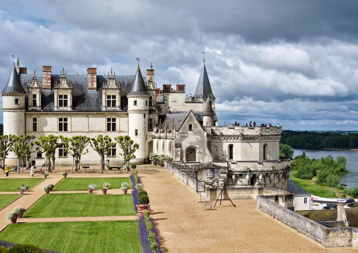 Château Royal d'Amboise with formal gardens under cloudy sky
