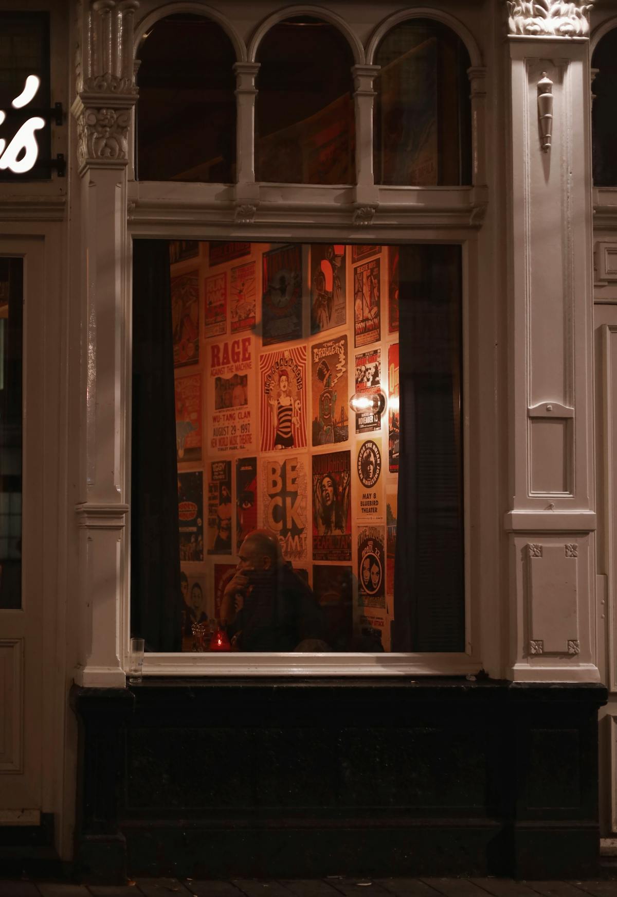 Cozy bar interior with posters at night in Amsterdam