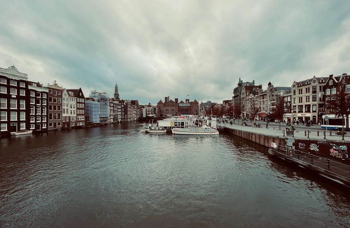 Classic Amsterdam canal scene with boats and traditional architecture