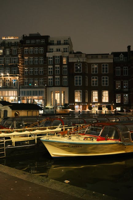 Amsterdam canal scene with boats and historic buildings