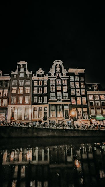 Amsterdam canal houses glowing at night in winter
