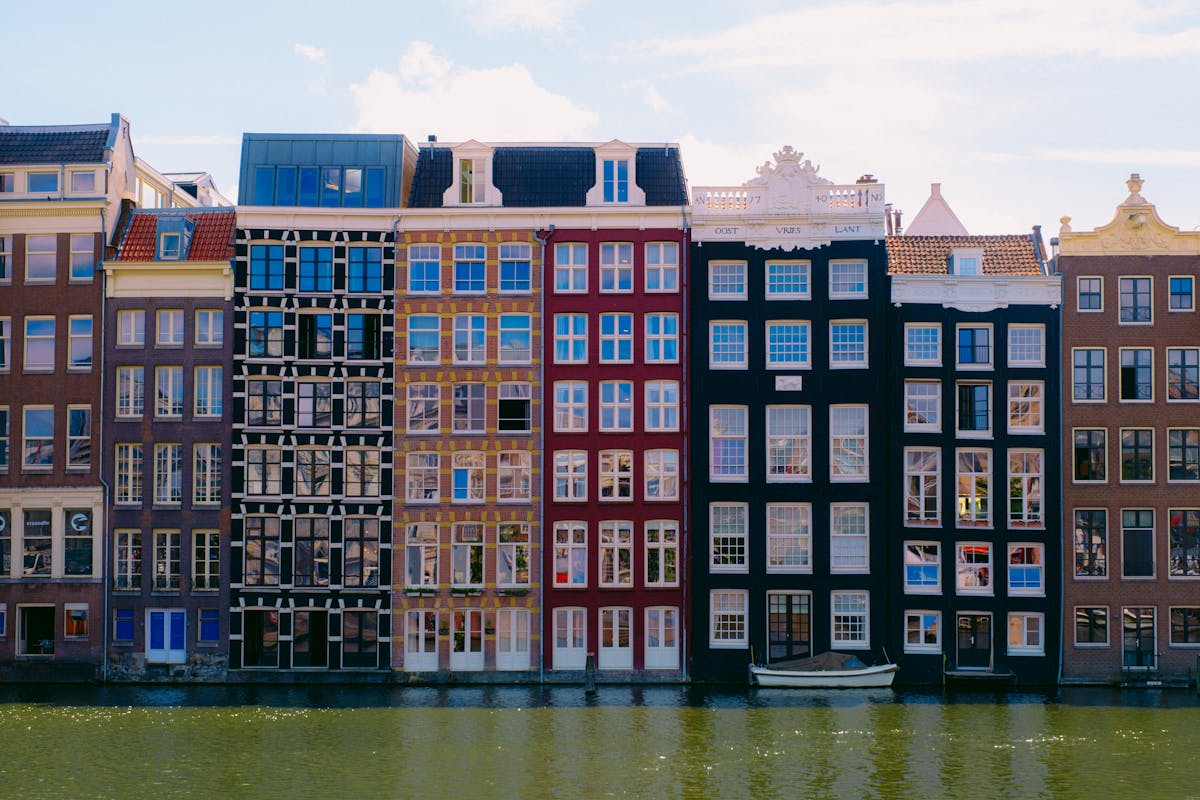 Vibrant facades of Amsterdam canal houses reflecting in water