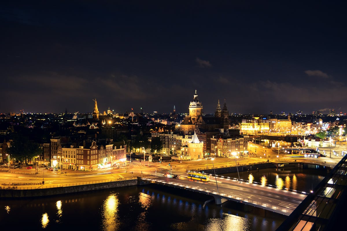 Amsterdam waterfront cityscape illuminated at night