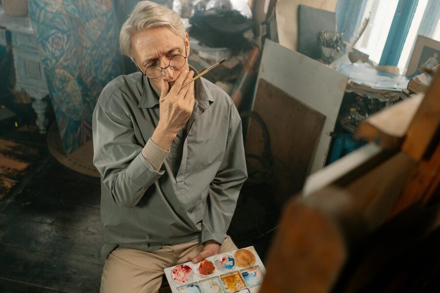 Artist painting at easel