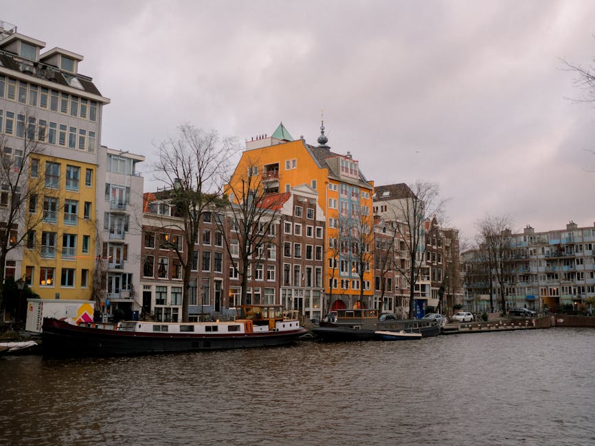 Amsterdam canal with traditional boats and brick buildings