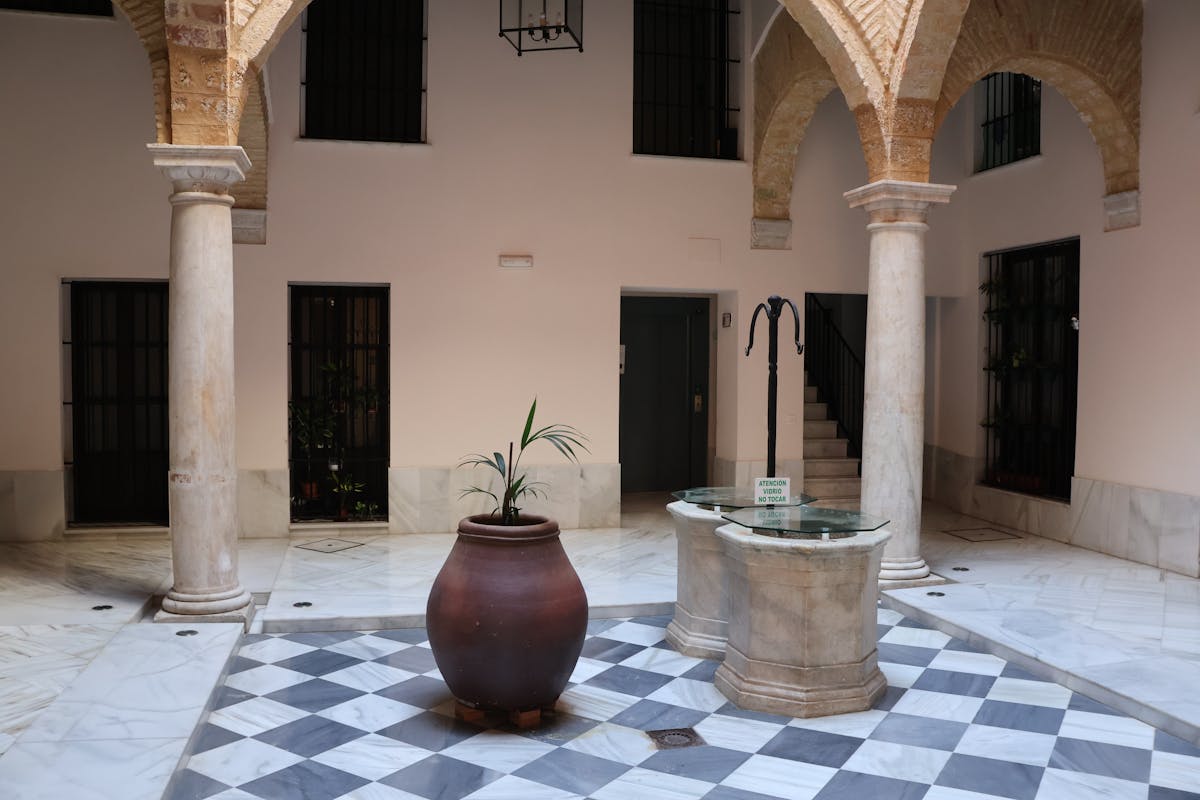 Elegant Andalusian courtyard with marble arches and ornamental flooring