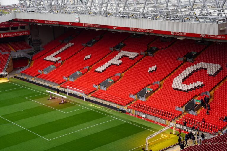 Rows of red seats at Anfield Stadium with LFC letters visible