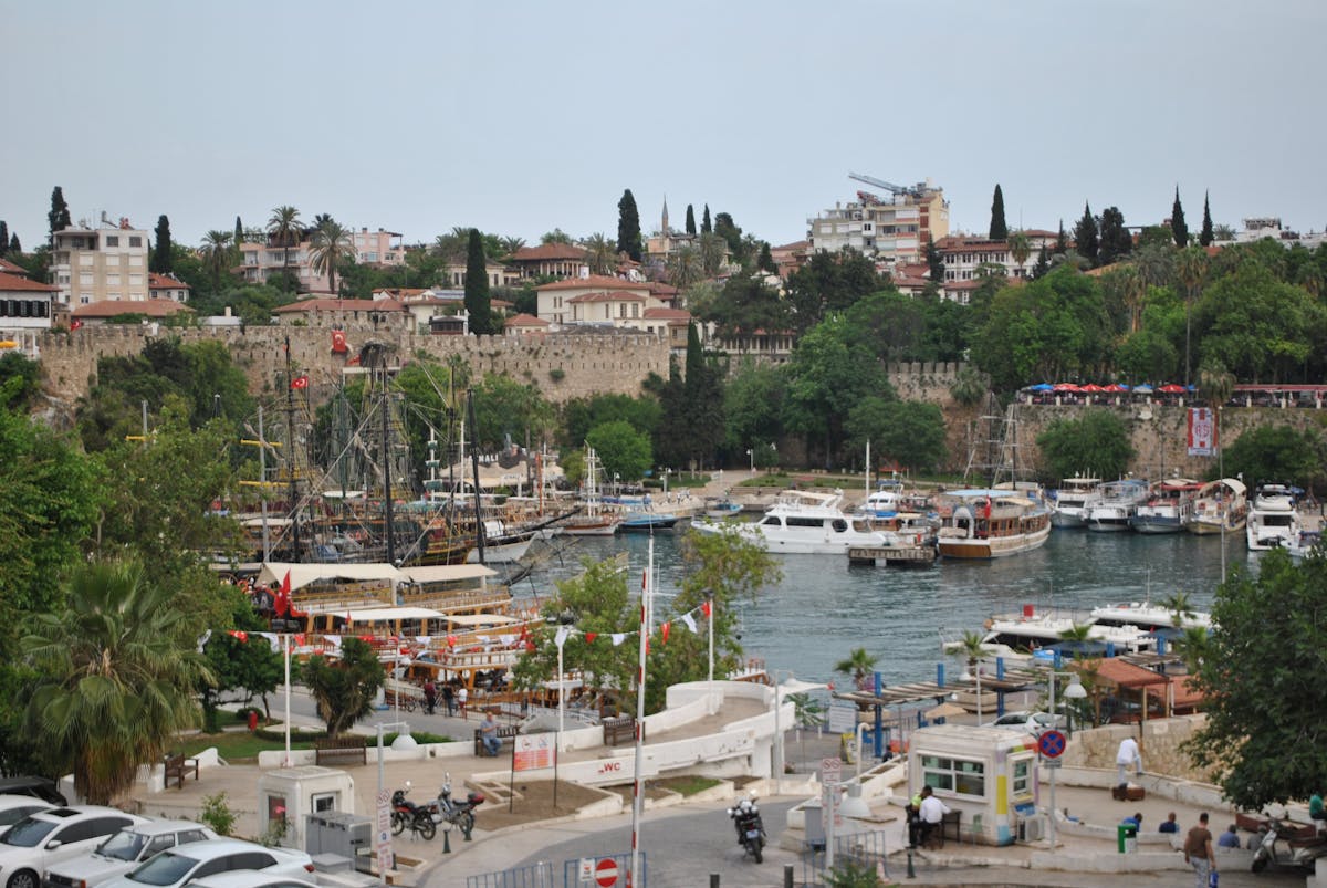Antalya harbour with traditional boats docked and historic buildings