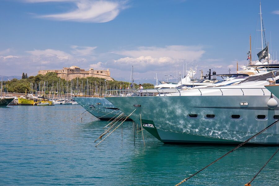 Antibes historic fortress and castle with boats and motorboats in port