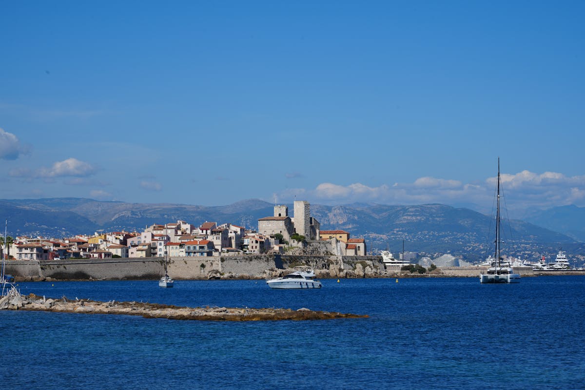 Antibes Old Town with historic buildings and peaceful marina harbour under blue sky