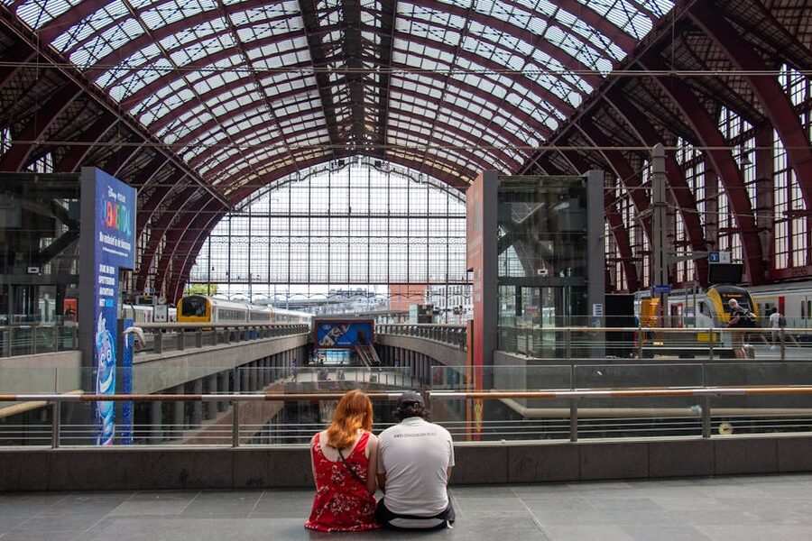 Couple sitting at Antwerp Central Station