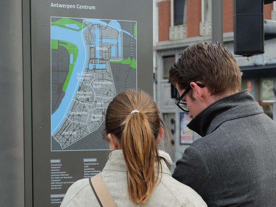 Tourists reading a map walking through Antwerp old town