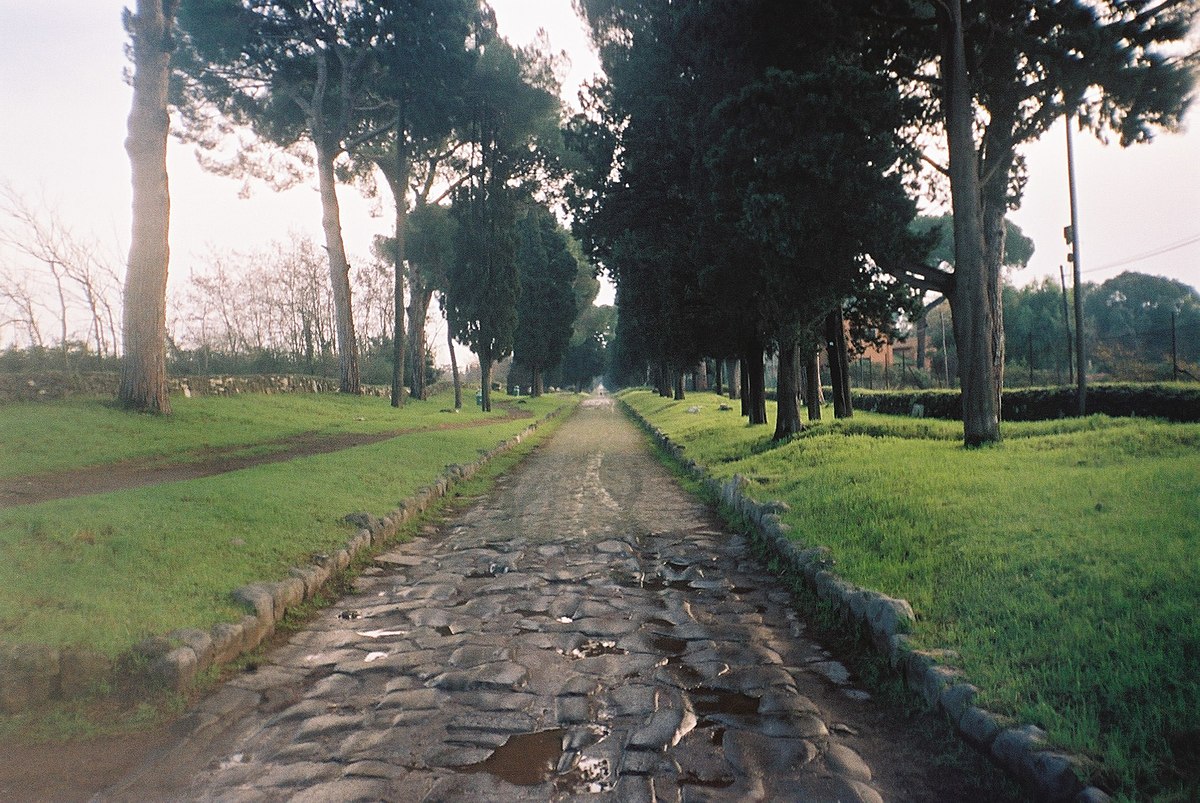 The ancient Via Appia Antica road with pine trees and old Roman tombs in Rome