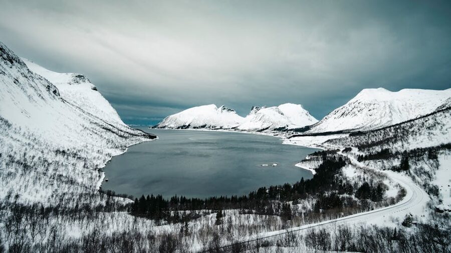 Arctic fjord with snow-covered mountains in Norway