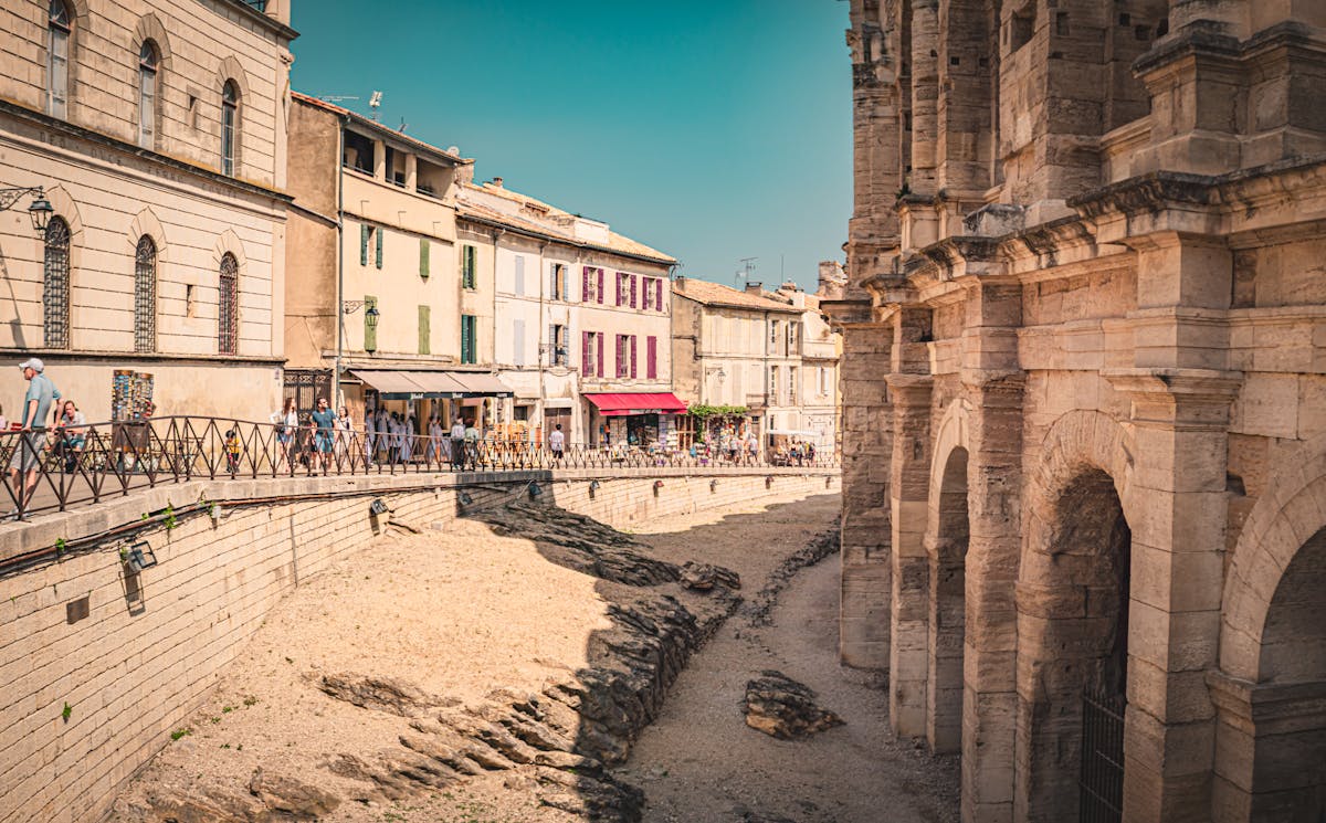 Picturesque street scene in Arles featuring historic architecture and summer ambiance