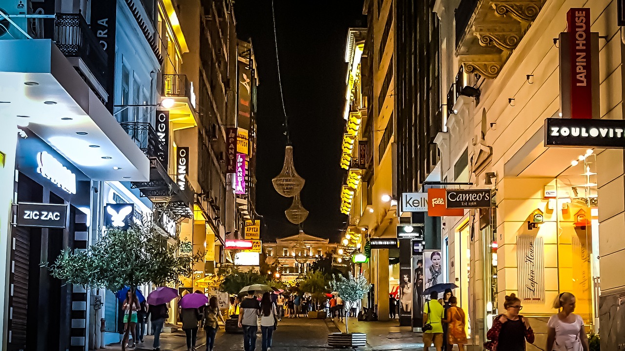 Evening view of Athens shopping streets with lights and shops in Plaka