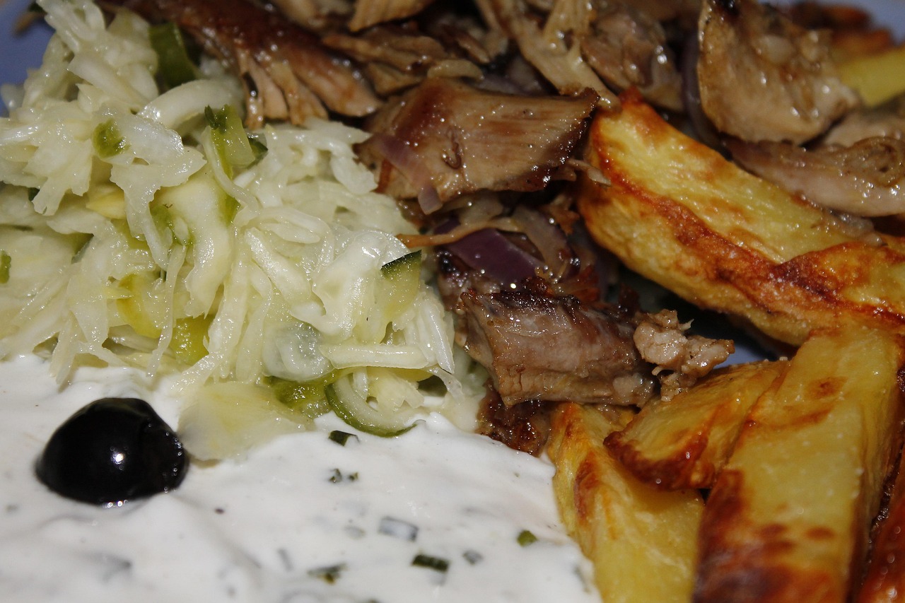 Traditional Greek gyros served with tzatziki sauce, fries and olives