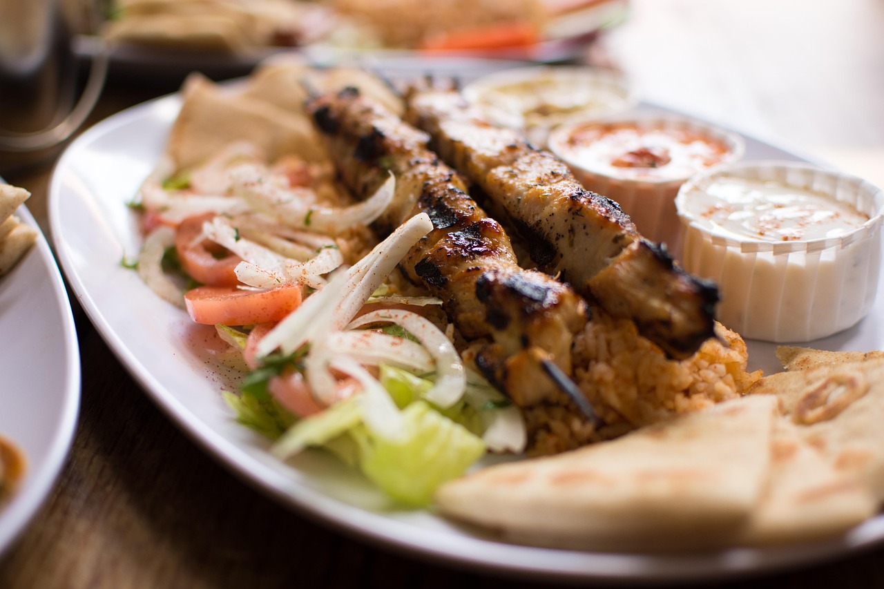 Close-up of authentic Greek souvlaki with mezze dishes
