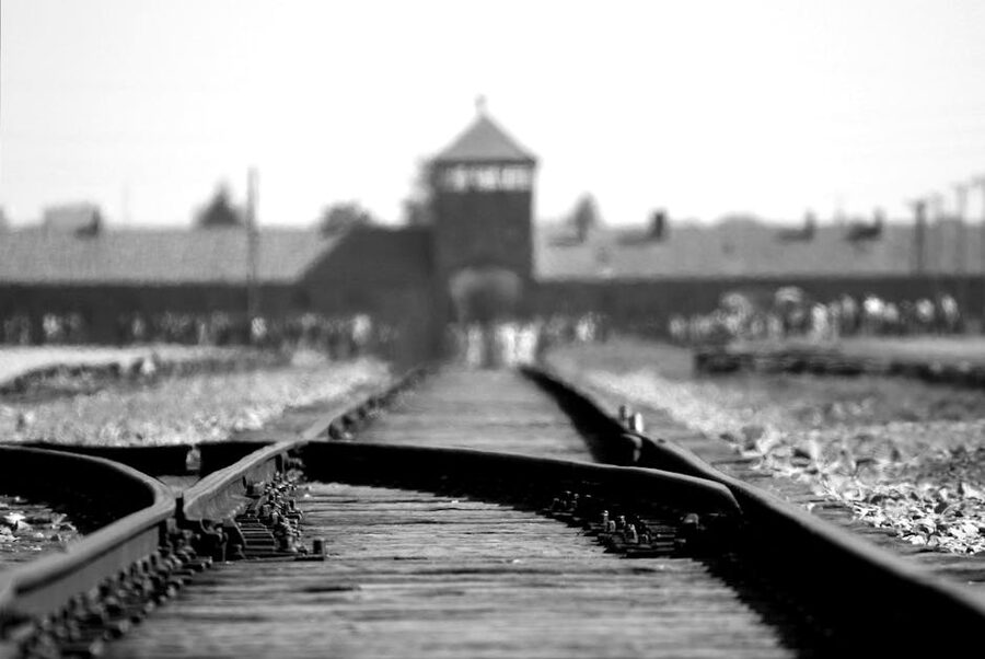 Black and white photograph of railway tracks at Birkenau