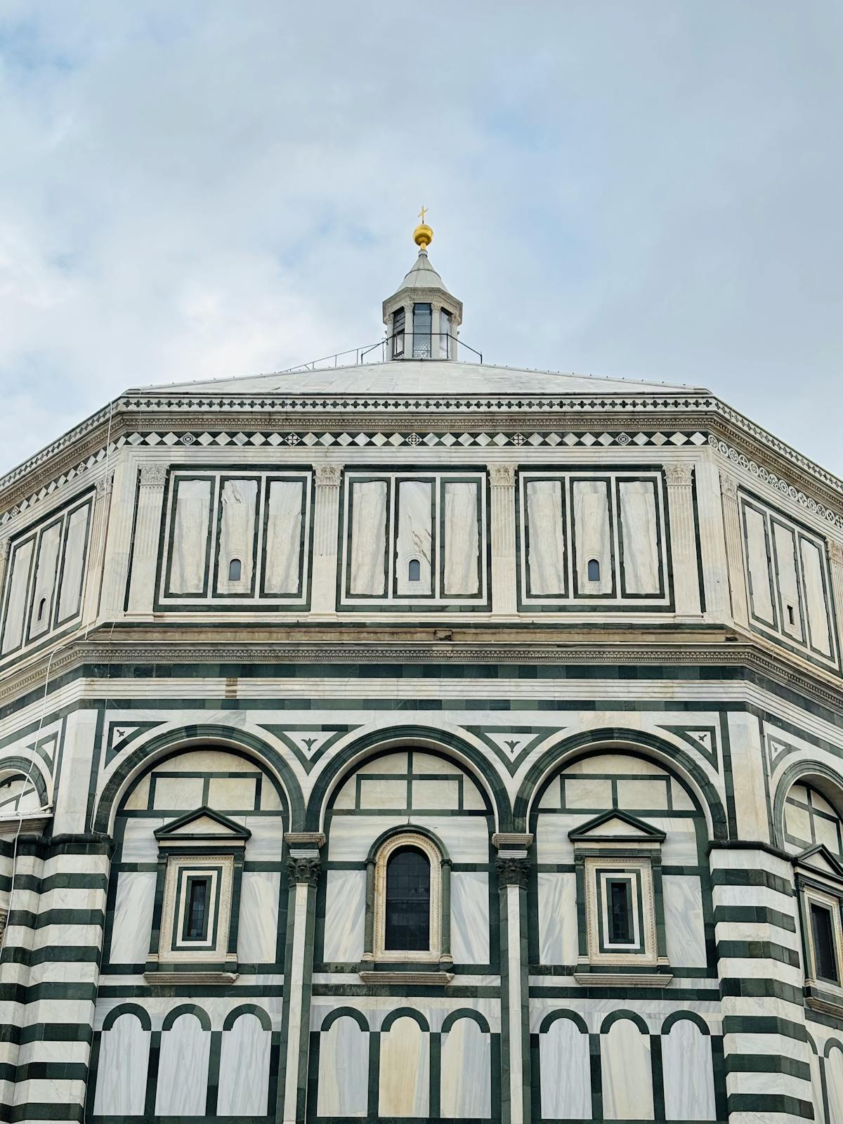 Close-up of the Florence Baptistery facade showing geometric green and white marble designs