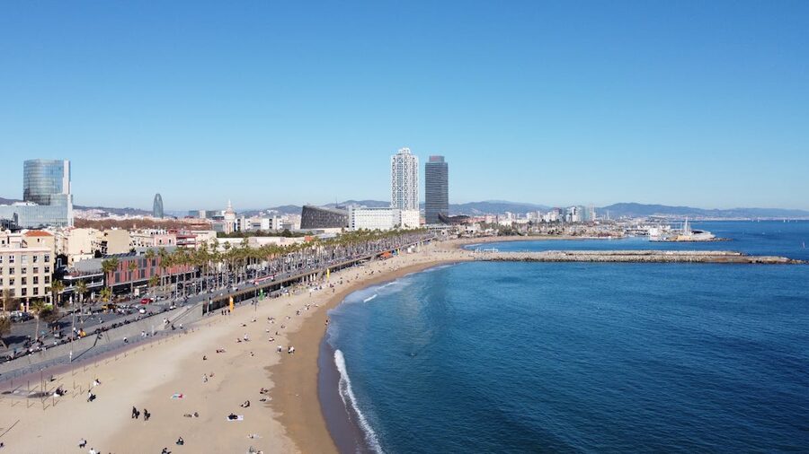 Aerial view of Barcelona beach and city skyline on a clear day