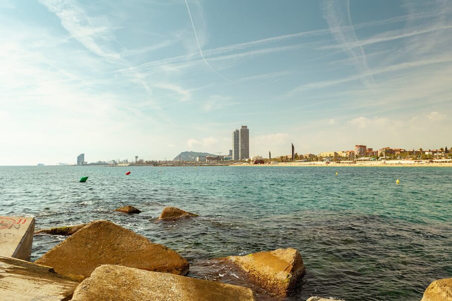 Barcelona beachfront with city skyline and blue Mediterranean water