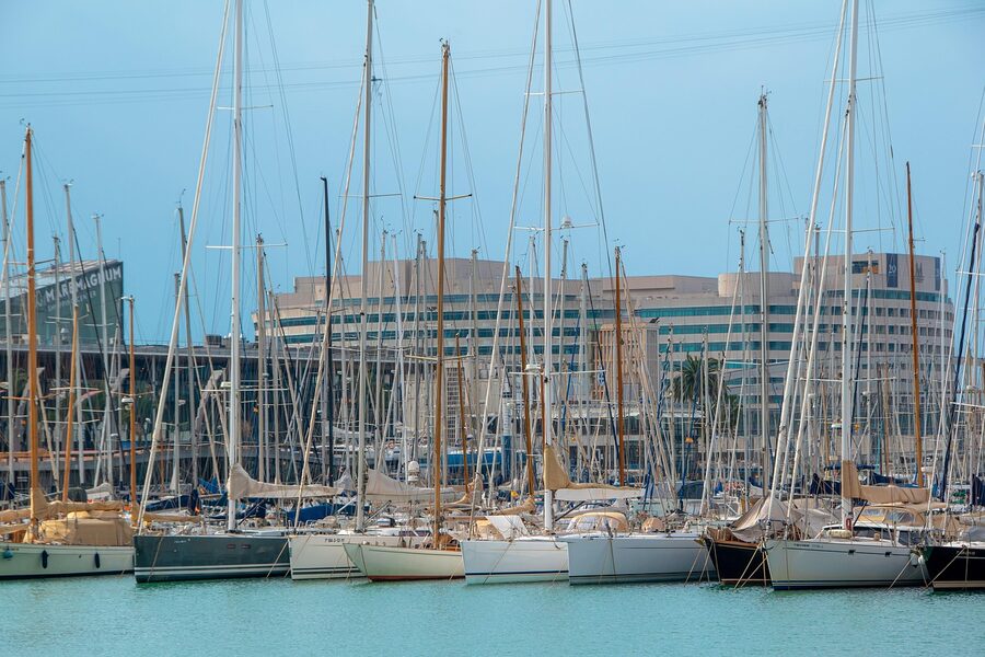 Barcelona harbour with tourist and commercial boats on sunny day