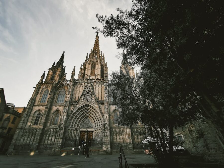 Gothic spires of Barcelona Cathedral against clear blue sky