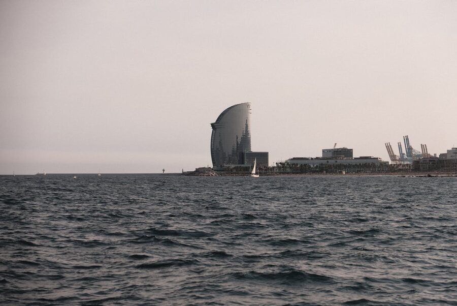 Barcelona coastline with sailboats at golden hour