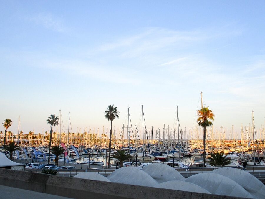 Barcelona port at dusk with boats and warm evening light