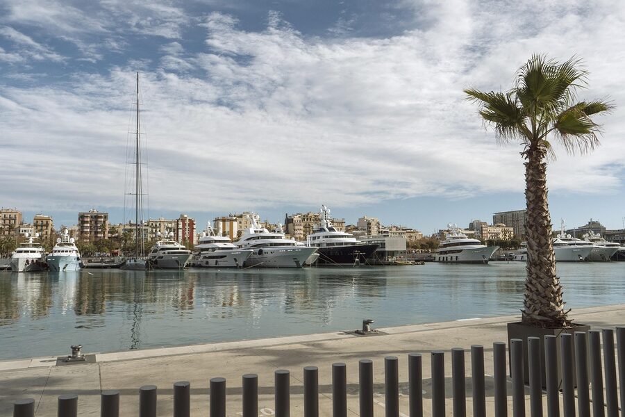 Port Vell yachts and marina with Barcelona city in the background