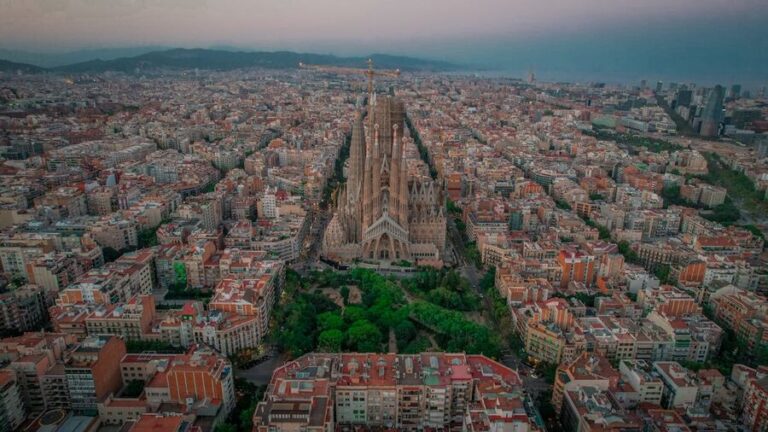 Aerial view of Sagrada Familia and Barcelona cityscape at twilight