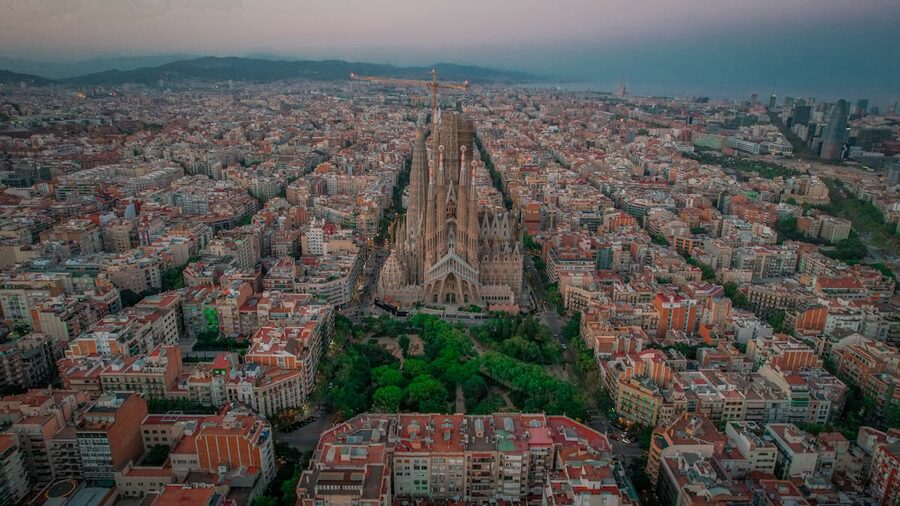 Aerial view of Sagrada Familia and Barcelona cityscape at twilight