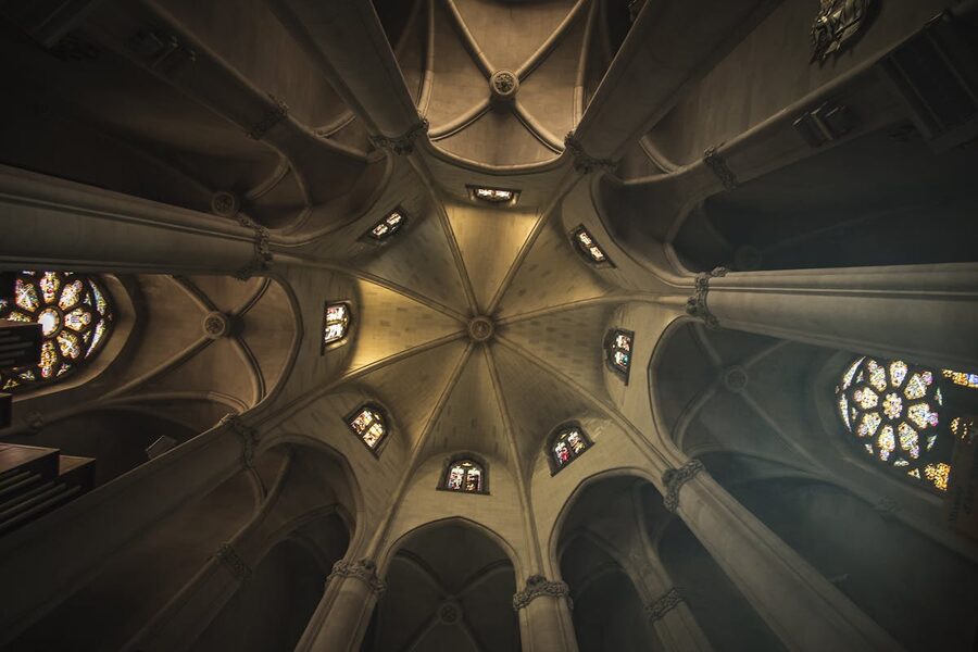 Ornate church ceiling with stained glass windows in Barcelona