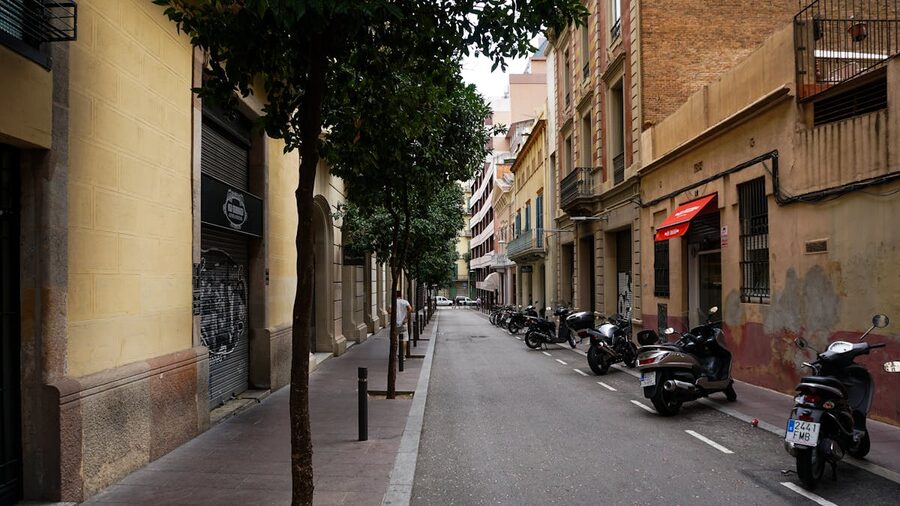 Barcelona street with parked motorbikes and classic architecture
