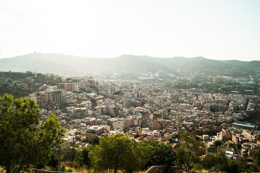 Barcelona city view from hilltop with mountains in background