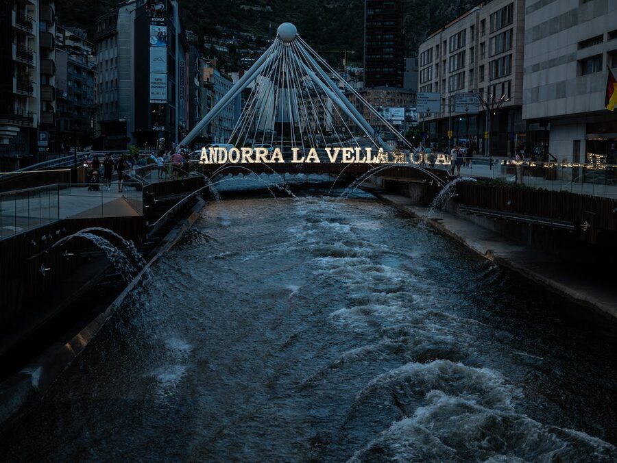 Andorra la Vella bridge over river at night with city lights