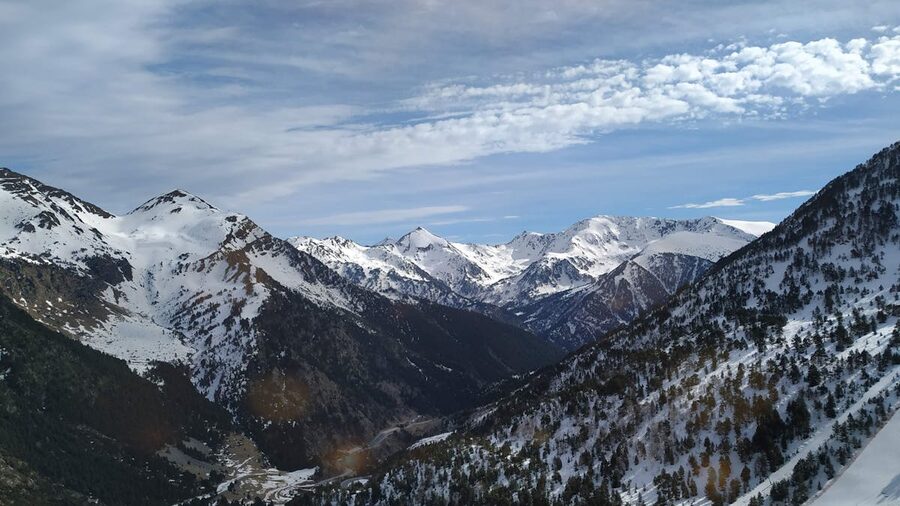 Snowcapped mountains in Ordino, Andorra under bright blue sky