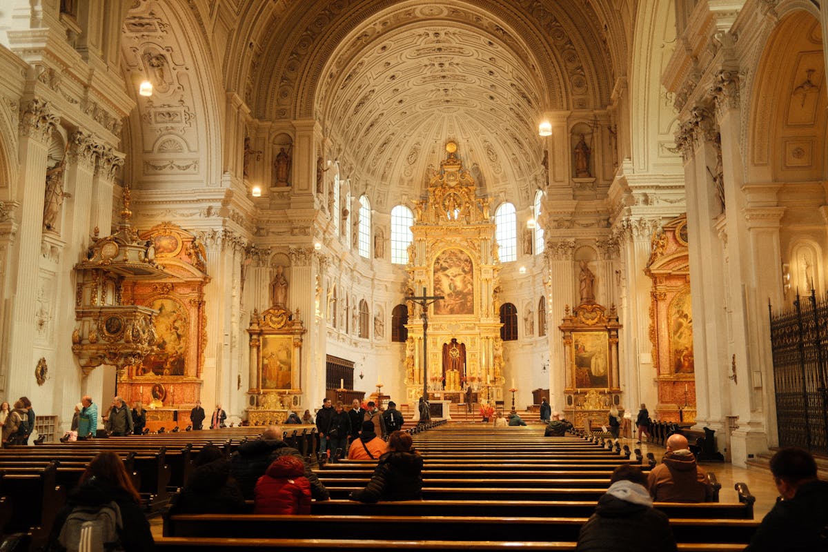 Ornate Baroque cathedral interior with visitors highlighting stunning architecture