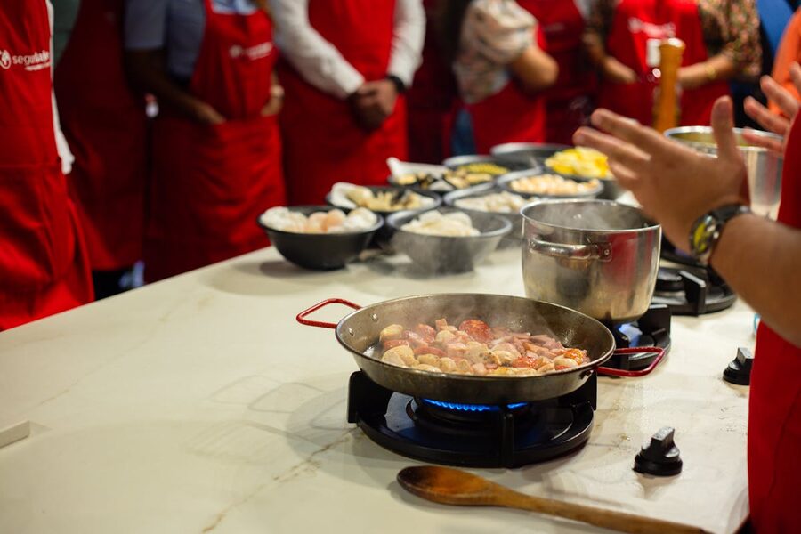 People learning cooking skills in a hands-on cooking class setting