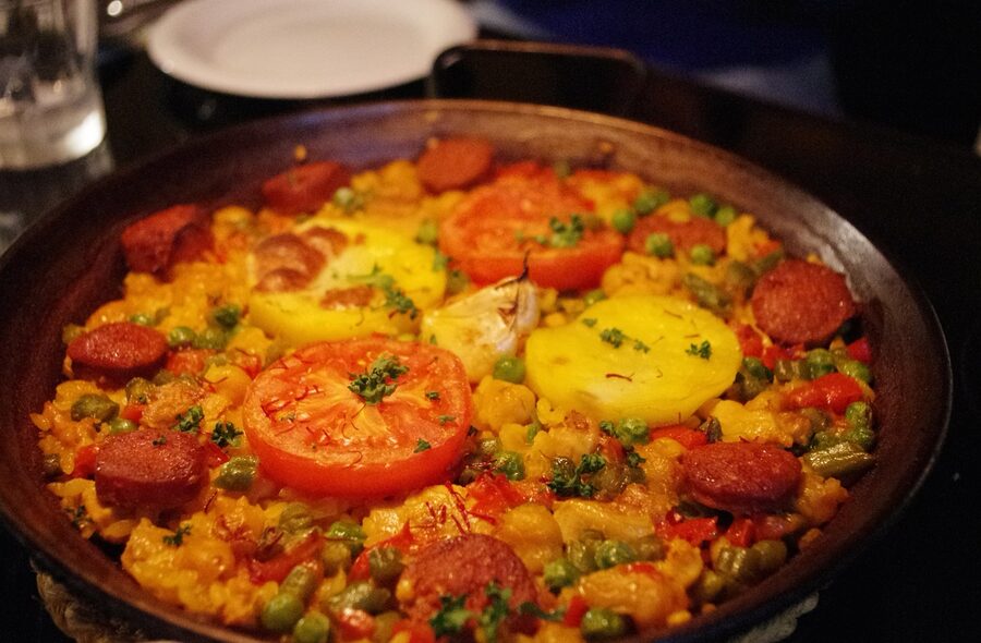 Traditional Spanish paella with rice seafood and lemon on a plate