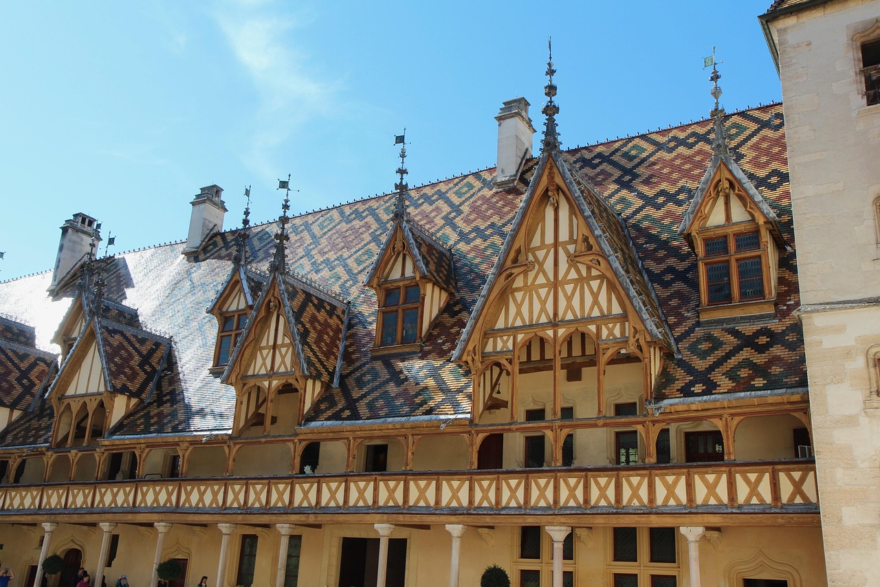 The polychrome glazed tile roof of the Hospices de Beaune reflecting sunlight in Burgundy France