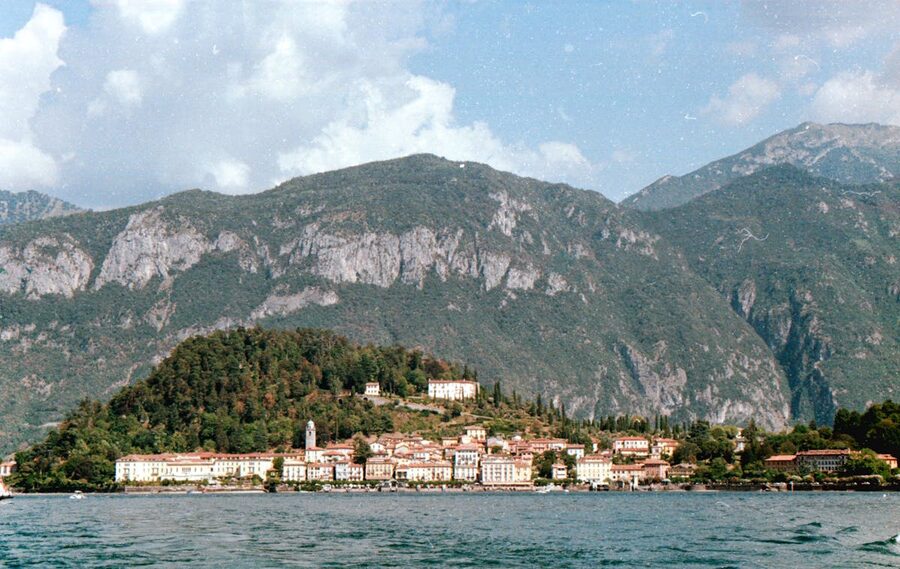 Bellagio village on Lake Como with mountain backdrop reflected in calm water