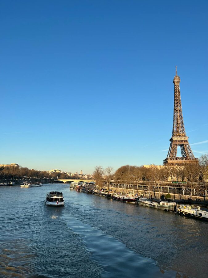 Looking up at the iron lattice structure of the Eiffel Tower from below