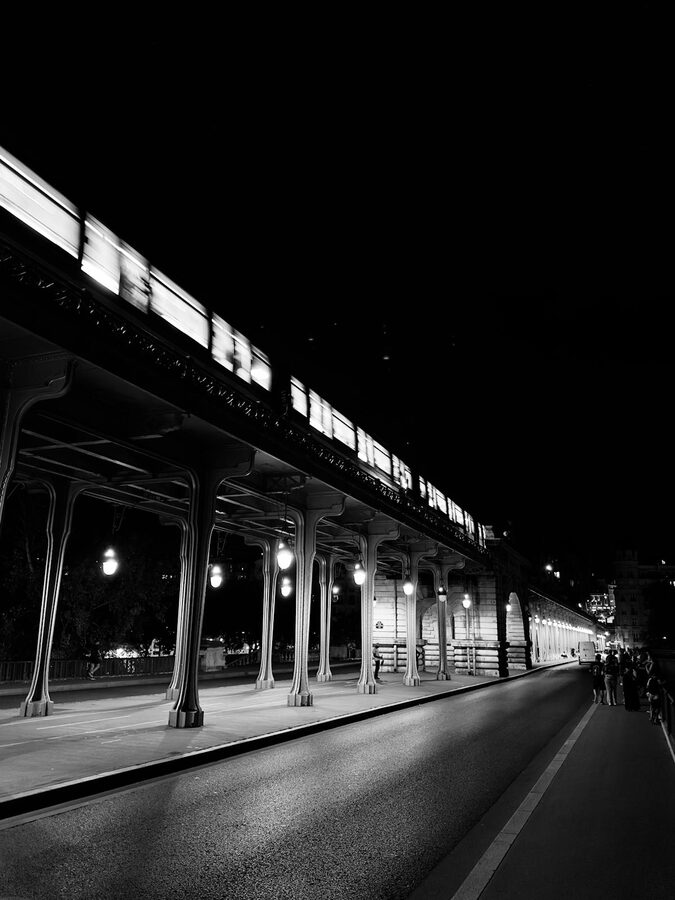 The Eiffel Tower at blue hour with dark blue sky and city lights in Paris